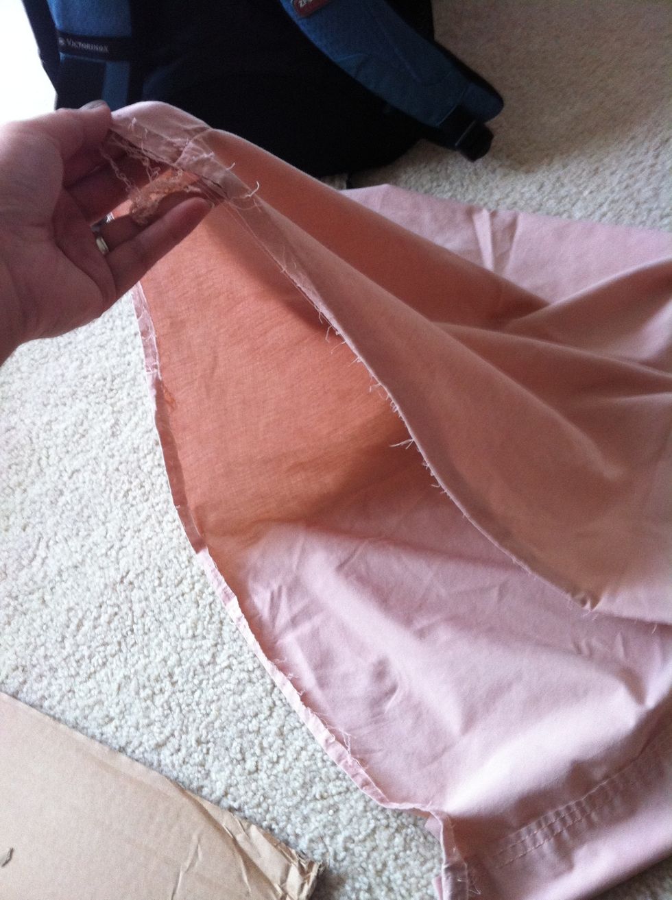 Take pillow case and open up seam with scissors to open it up. We will be using the folded seam as the bottom part of the curtain.