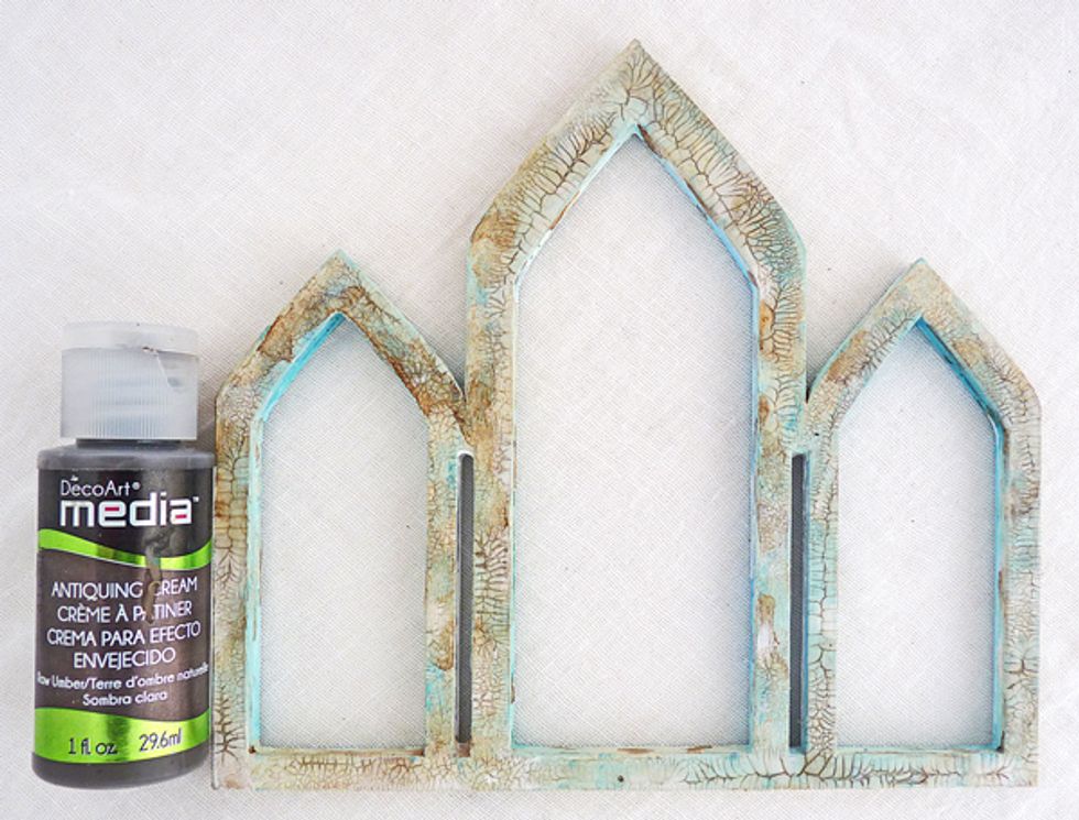 Take Raw Umber Antiquing Cream and rub a little over the frame and wipe back straight away with a babywipe so that the cracks are enhanced but not the rest of the wood.