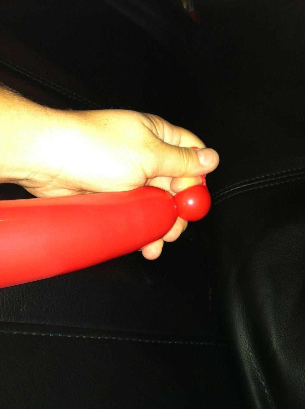Take red balloon and twist off a tiny bubble and pinch twist it (bean twist)