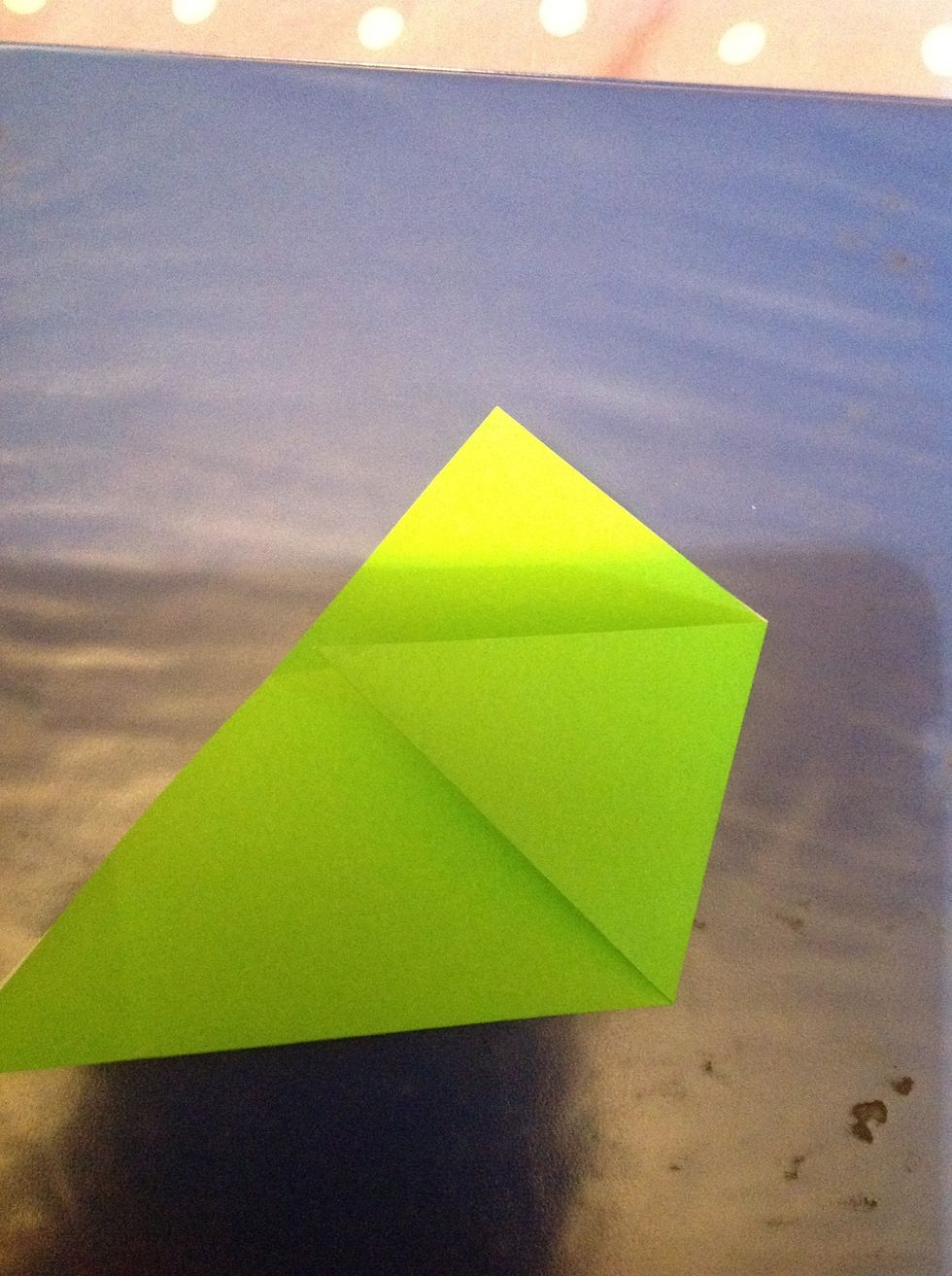 Take right corner of triangle and fold to touch point where the crease from last fold is shown