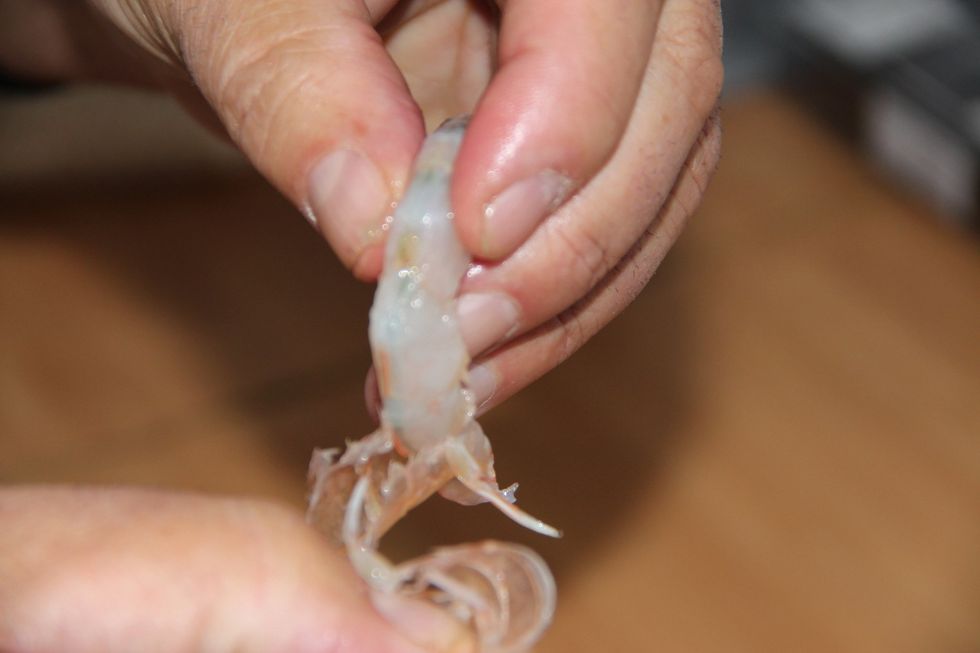 Take shells off and clean out black lining of intestines