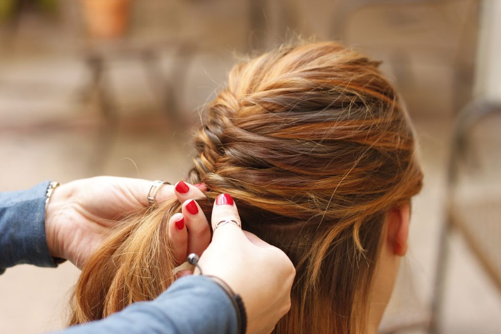 Take slightly thicker sections of hair from the side that you want the braid to sweep away from.