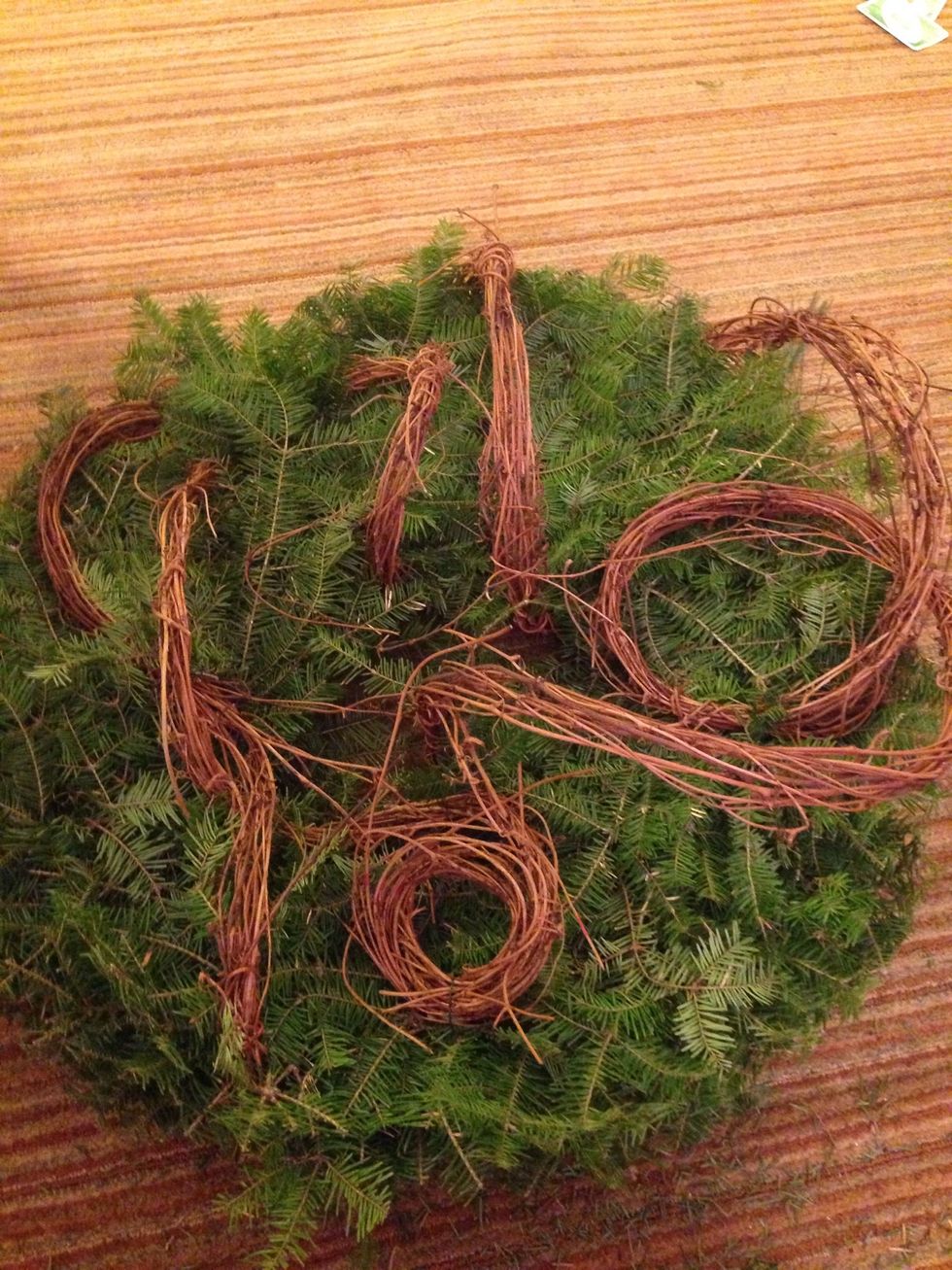 Take small pieces of wire and bring the grapevine garland loops closer to the wreath making it more flush to the design.