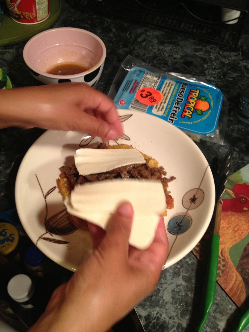 Take some cheese any cheese that melts nicely, In my case I had no mozzarella So I used frying cheese. Put it right in top of the meat. Put it under the broiler or micro to melt