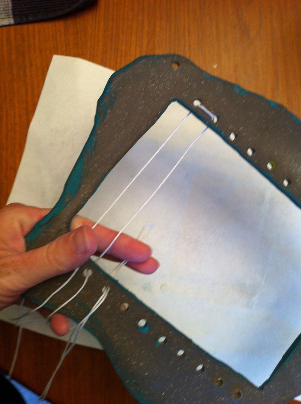 Take some cotton yarn and go up, around and back all the way across the loom.