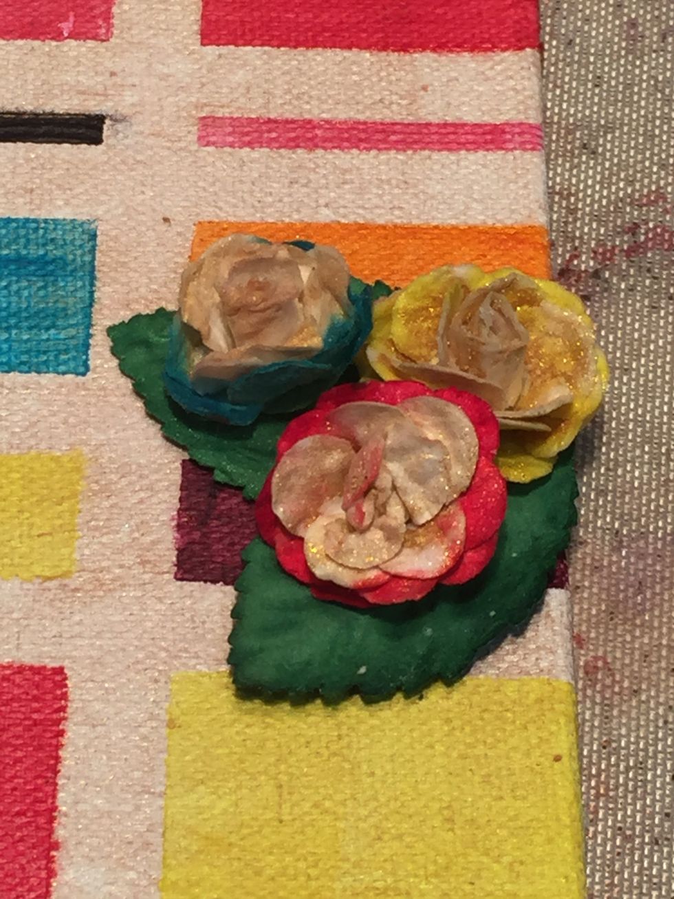 Take some white Prima roses & paint the inside with Gold Dust Minx, & the outside with Indulgence, Panache, & Allure.  Paint the leaves with Bankroll.  I found the dropper works best on the roses.