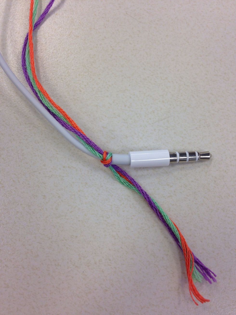 Take the 3 threads and tie them to the end of the headphones.