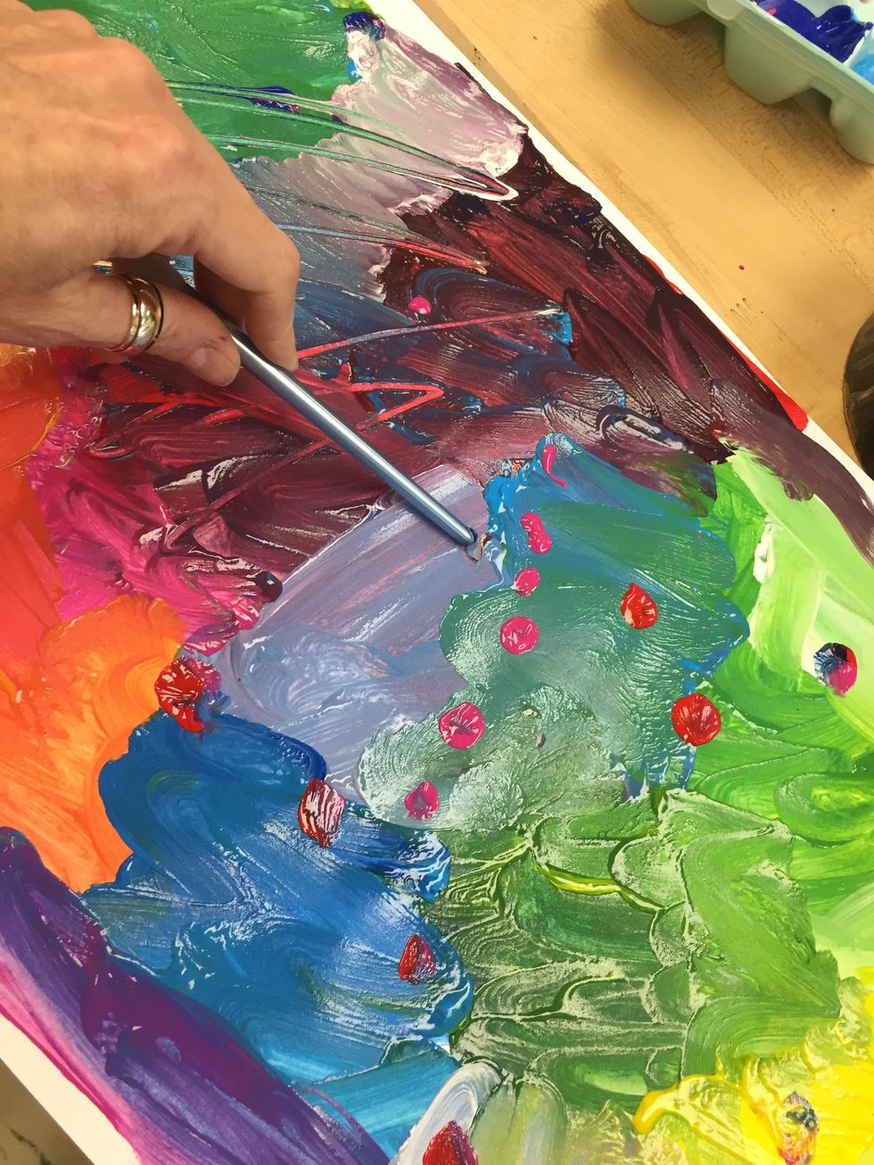 Take the back of your paint brush to scratch into the wet paint. For your very last mark, add a few dots on the top