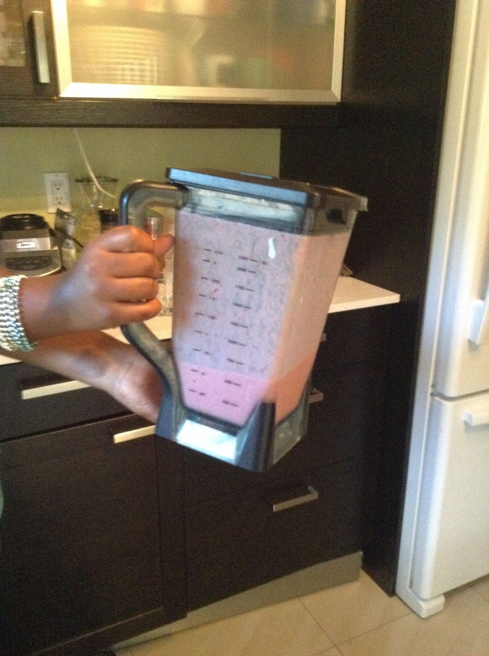 Take the blender off its stand and get ready to pour.