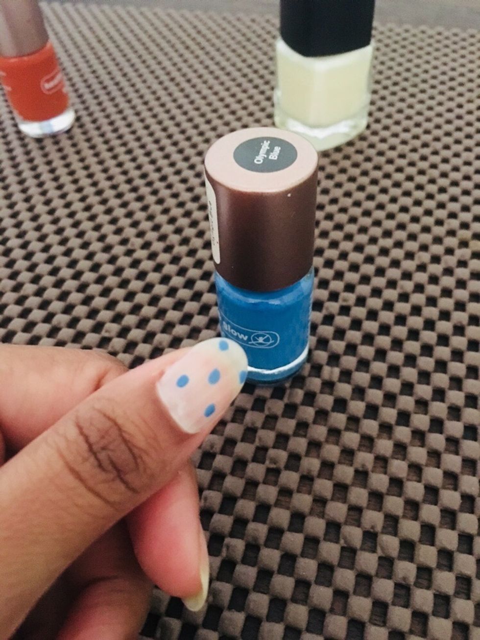 Take the blue color and make small random dots on the nails