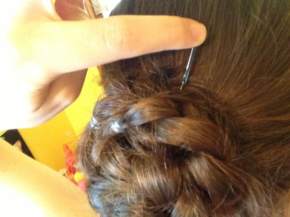 Take the bobby pins and put them all around your braided bun, pushing them in!