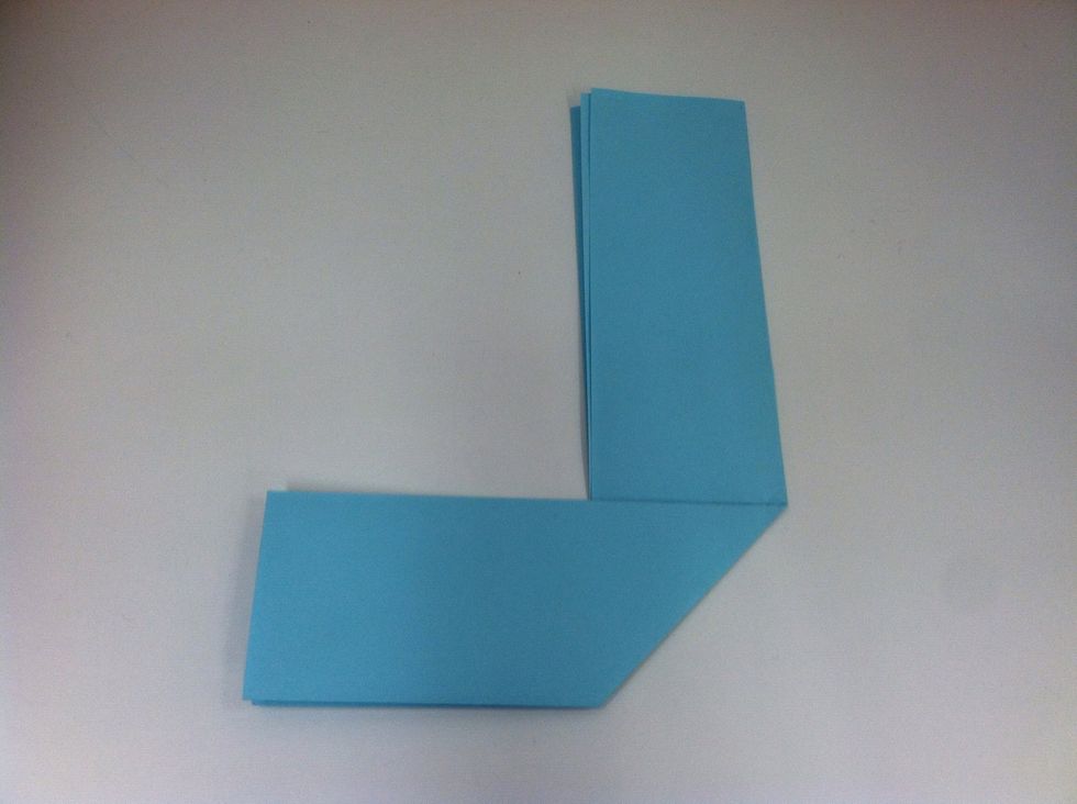 Take the bottom half, and fold it over to the left so that the edge runs along the line you drew. It should look like a backwards "L".