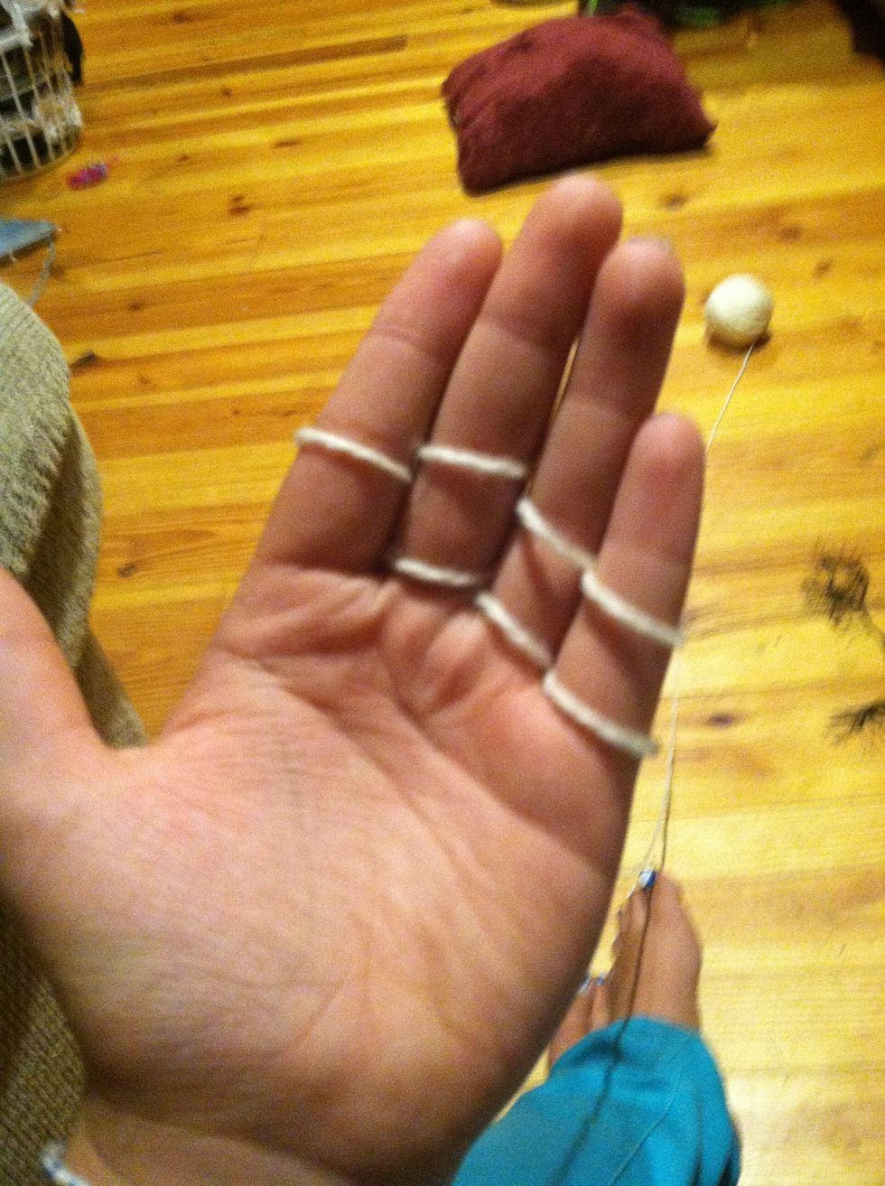 Take the bottom loop and take it over your finger, leaving the top one.