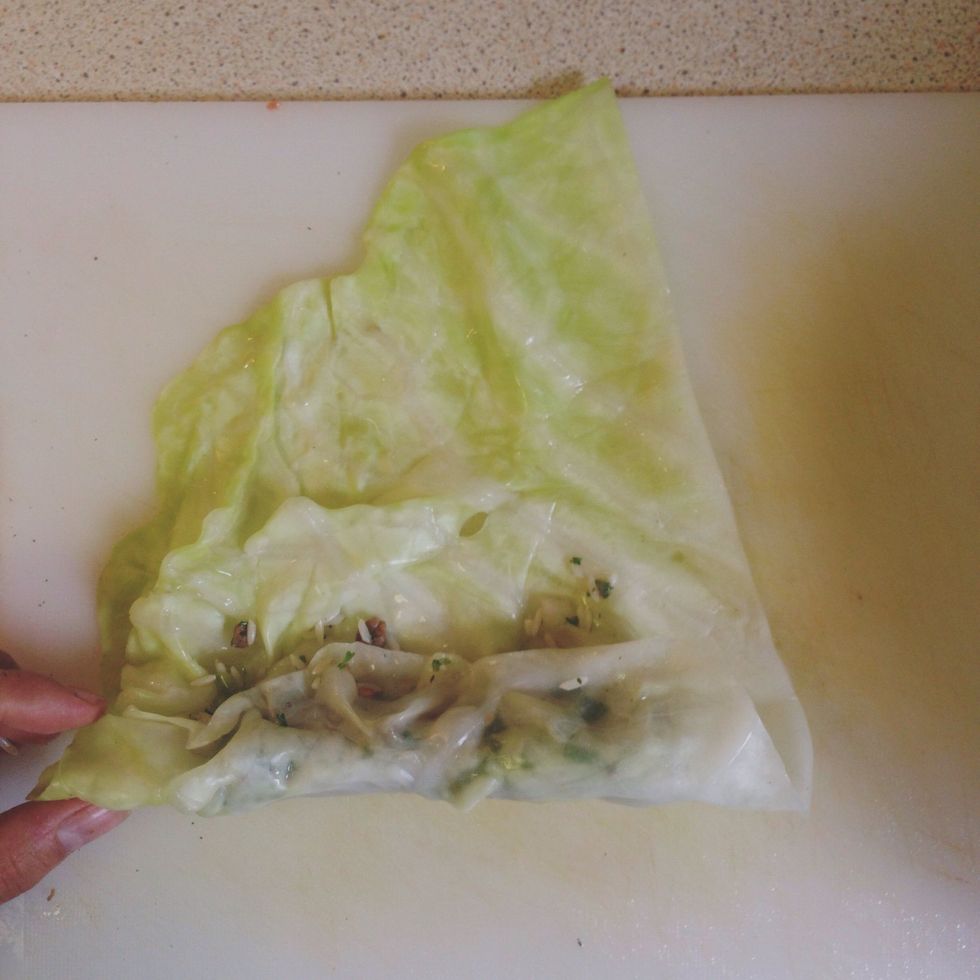 Take the bottom of the cabbage leaf and roll up until filling is entirely covered by leaf.
