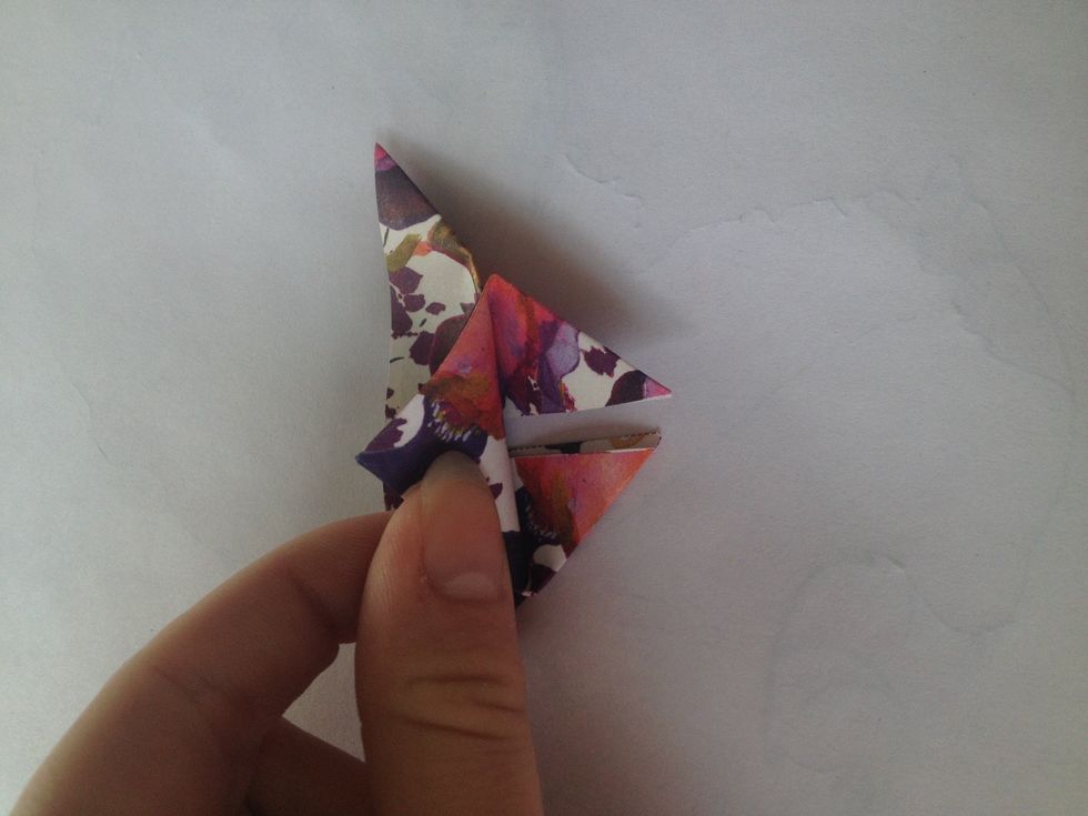 Take the bottom point and fold to the top, the top should be over the flat edge of your triangle