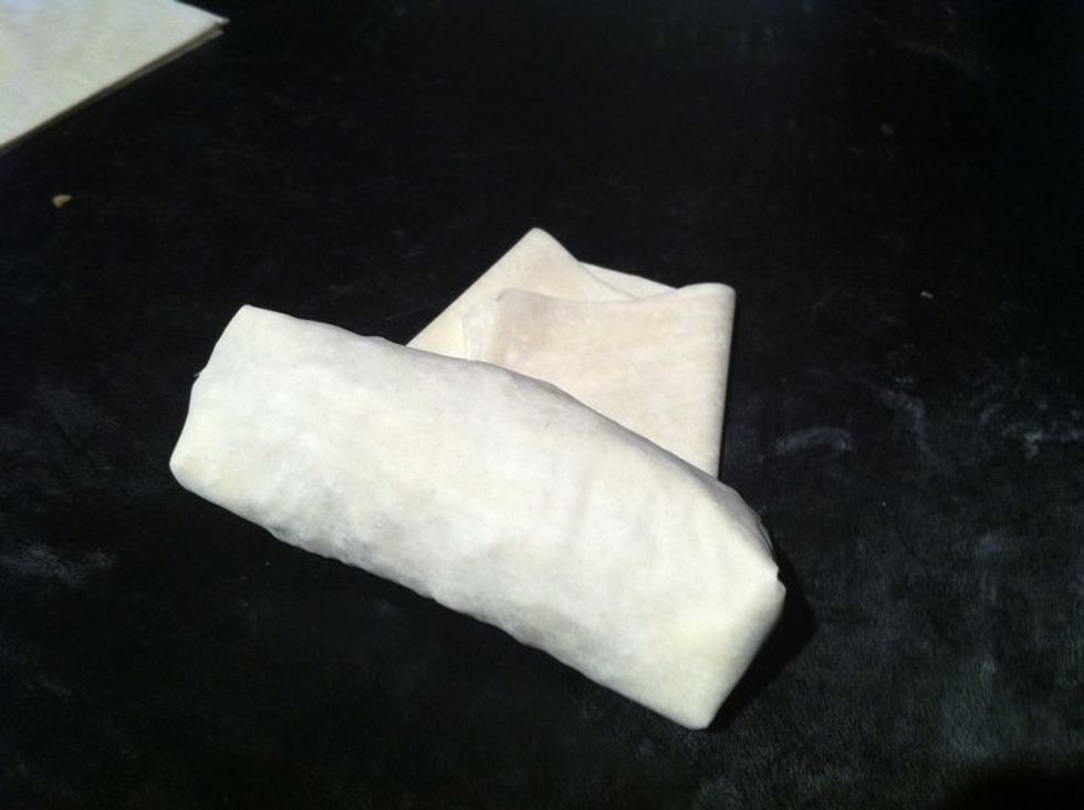 Take the bulky end and roll forward towards the opposite end of the phyllo sheet.