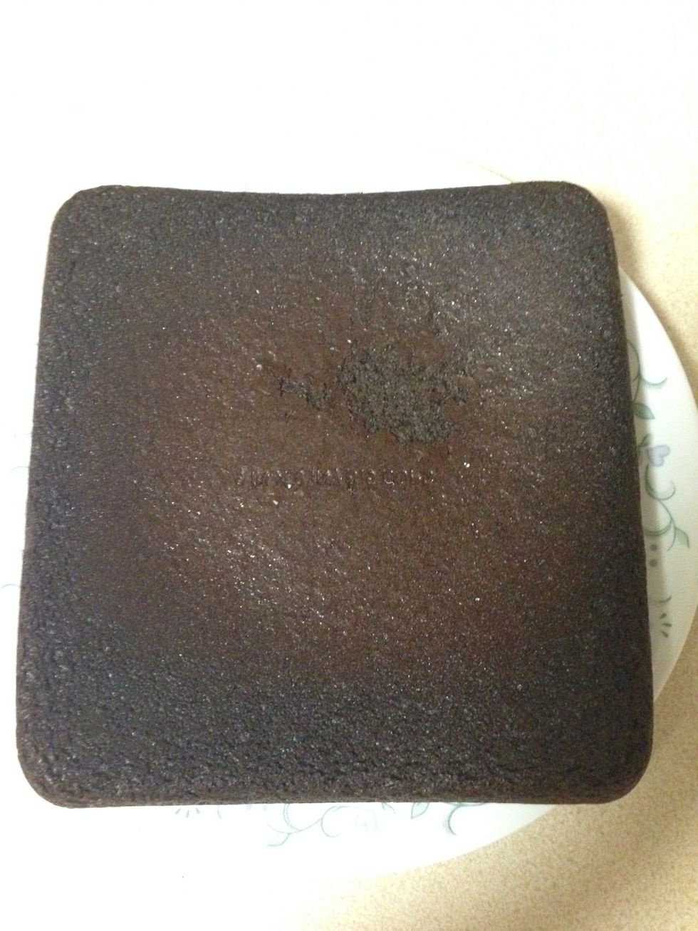 Take the cake out of the hot baking dish to stop additional cooking.