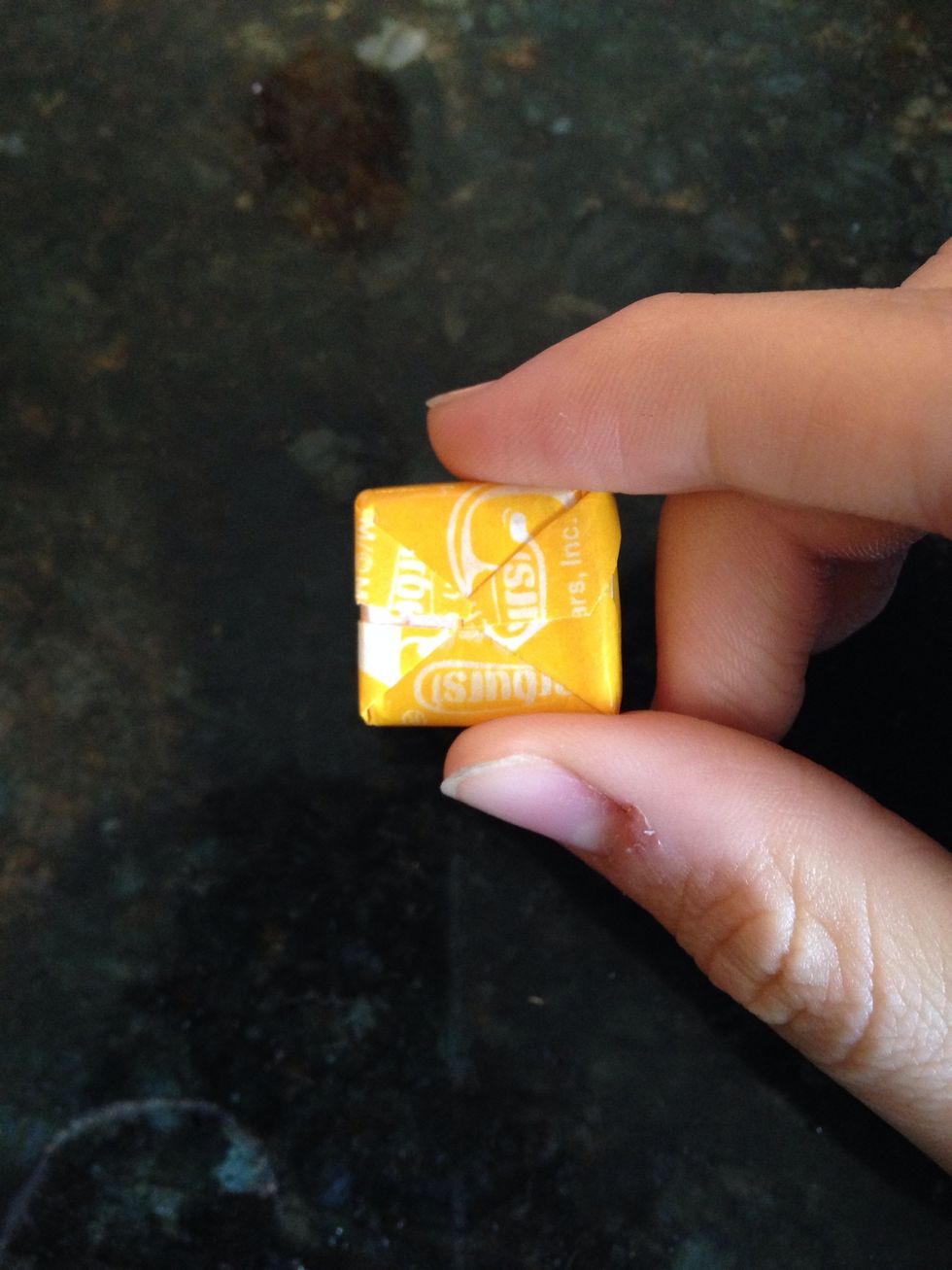 Take the candy and turn it to the back.