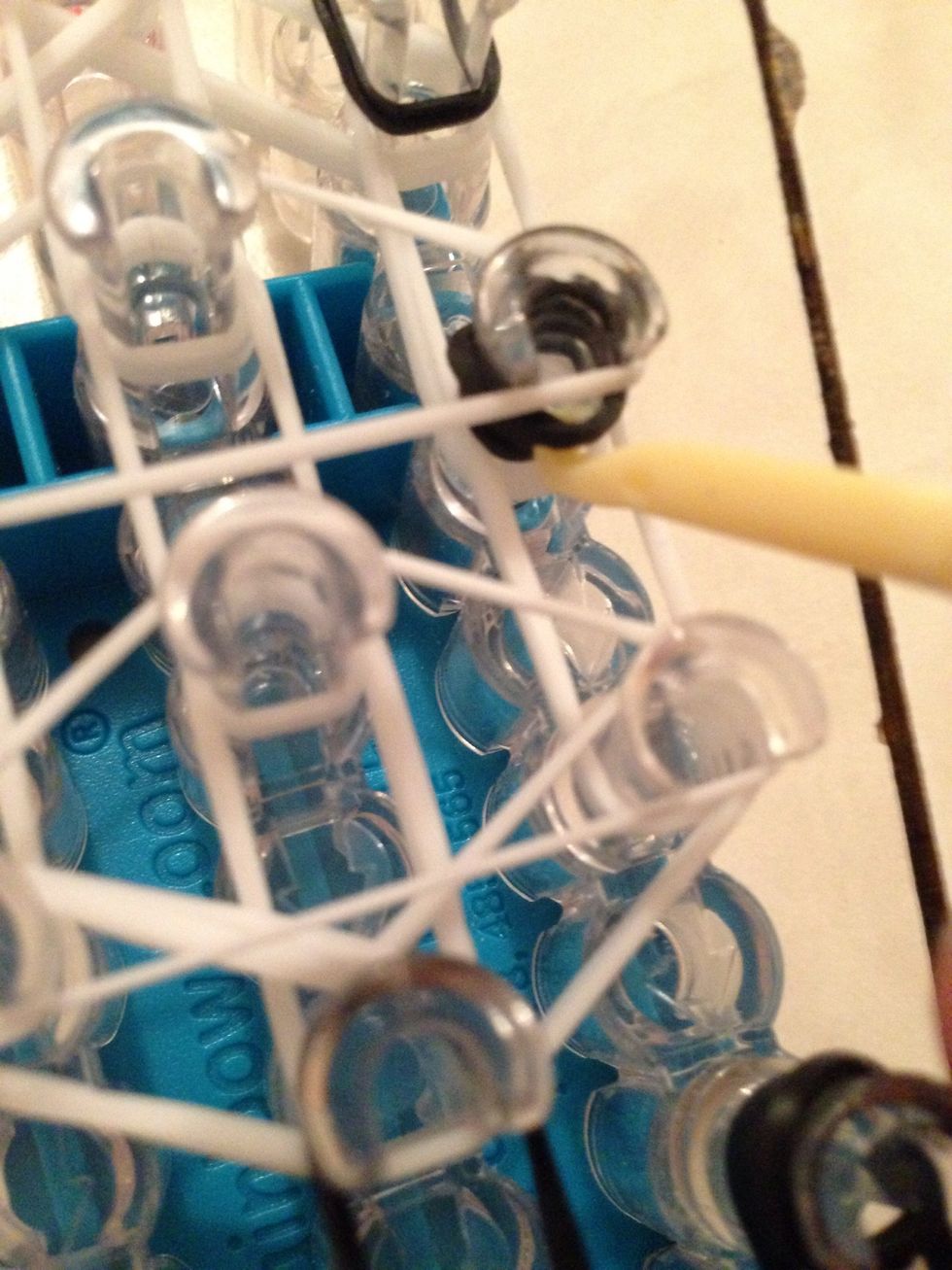 Take the cap bands and pull over the white triangle