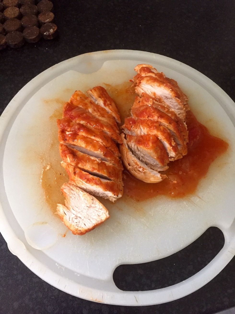 Take the chicken breasts and cut them in slices. Put them back in the sauce
