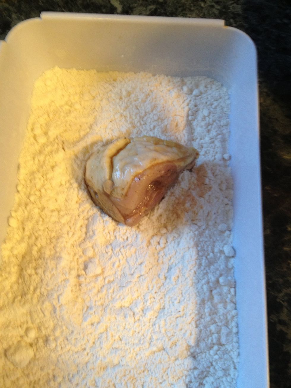 Take the chicken pieces and start dipping them In the flour