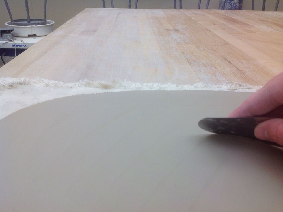 Take the clay back to your table and smooth it with a metal rib.