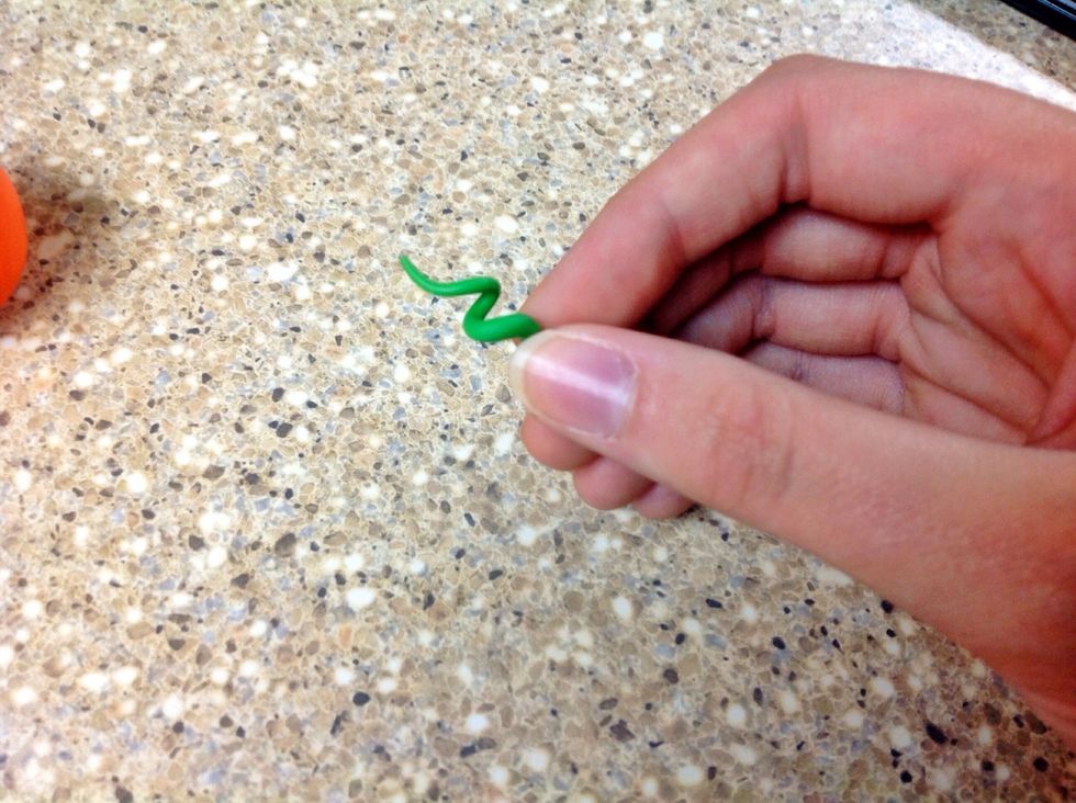 Take the clay "snake" and gently twist it into a spiral.