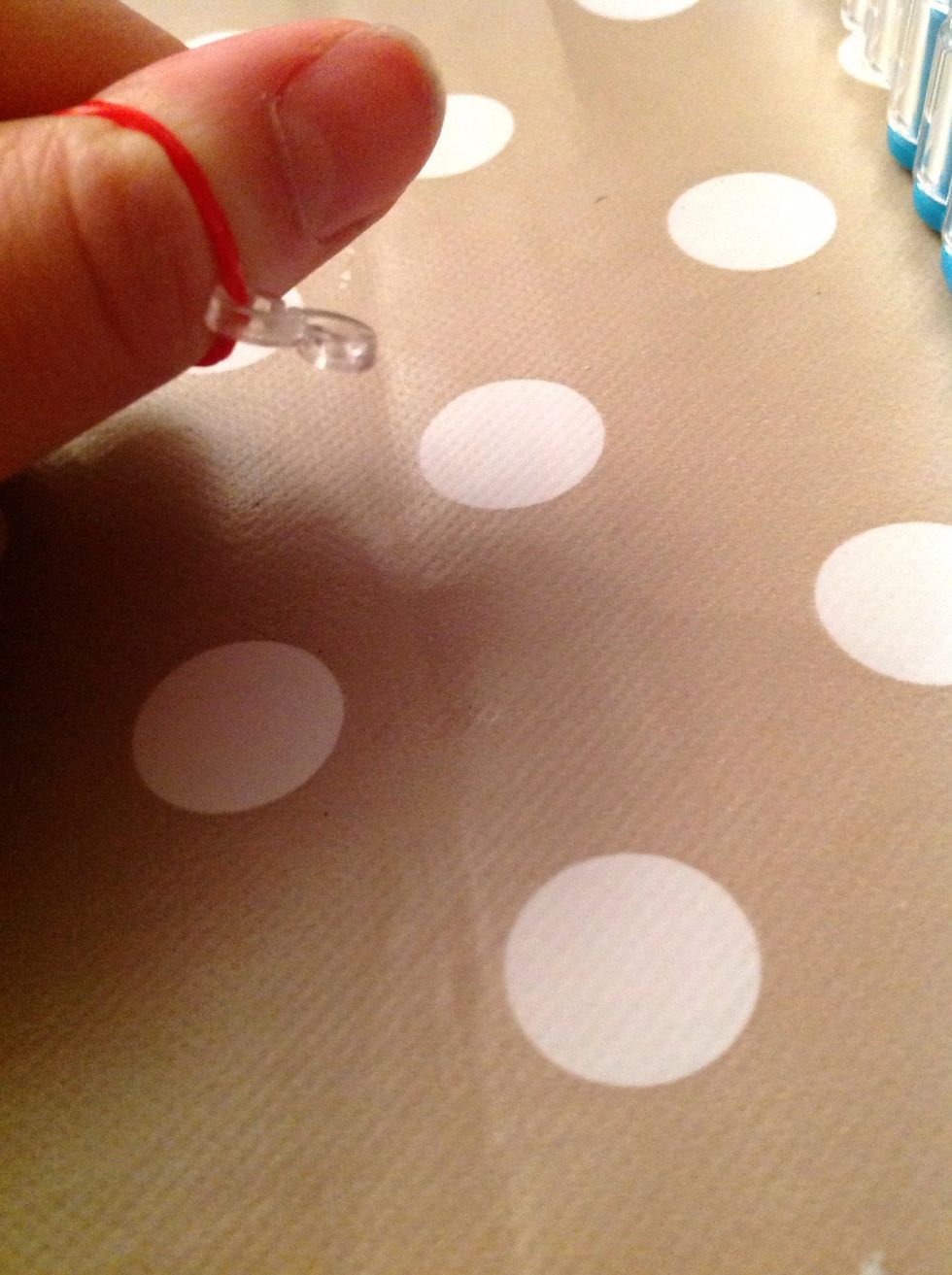 Take the clip of the band it's on and keep the band on your thumb so the bracelet doesn't fall apart.