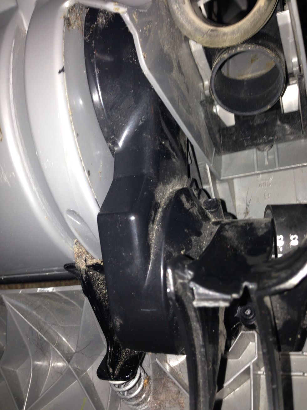 Take the clutch cover and simply push it down into place over the belt you just installed. It should snap in when pushed firmly down