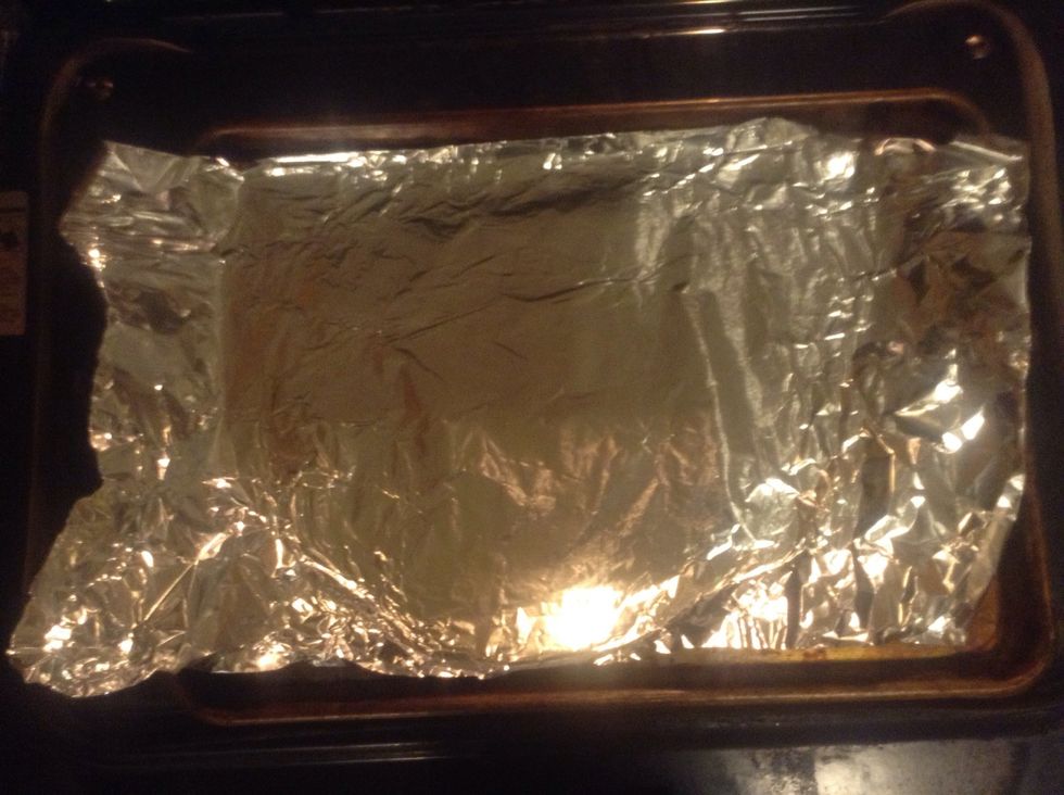 Take the cookie pan and cover it with the aluminum foil.