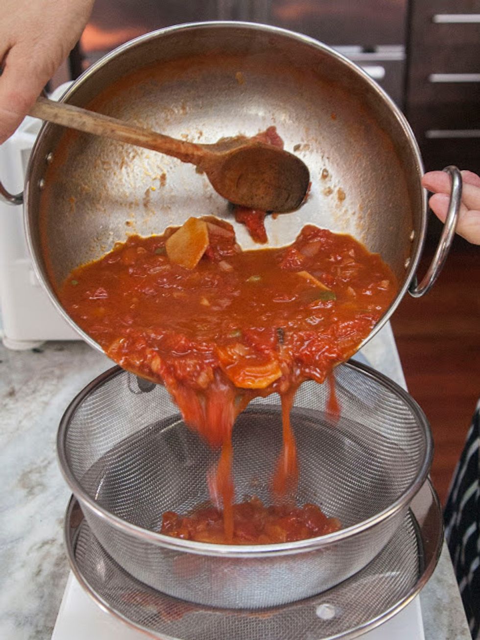 Take the cooled sauce and either run it through a food mill, (I don't have one) or a fine mesh strainer placed over a bowl.