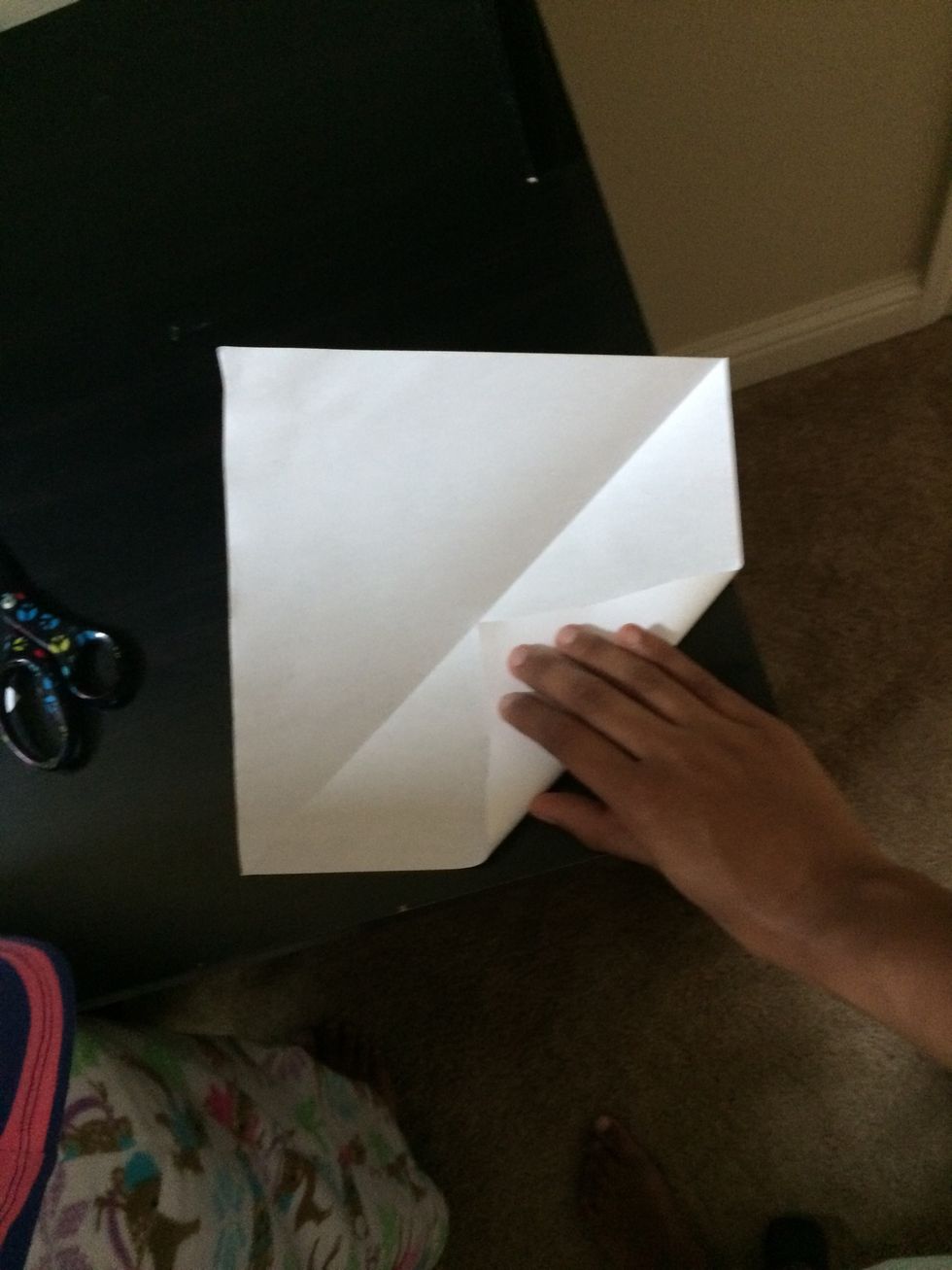 Take the corners of your triangle and fold it into the middle.