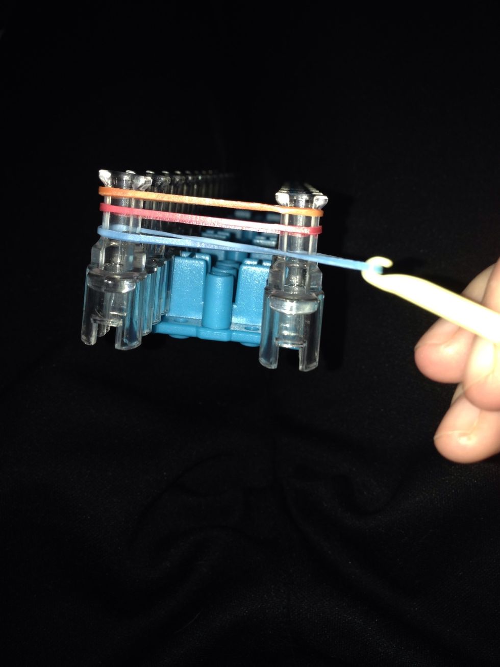 Take the crossed one and over lap the "blue" elastic over top on the 2 other colors