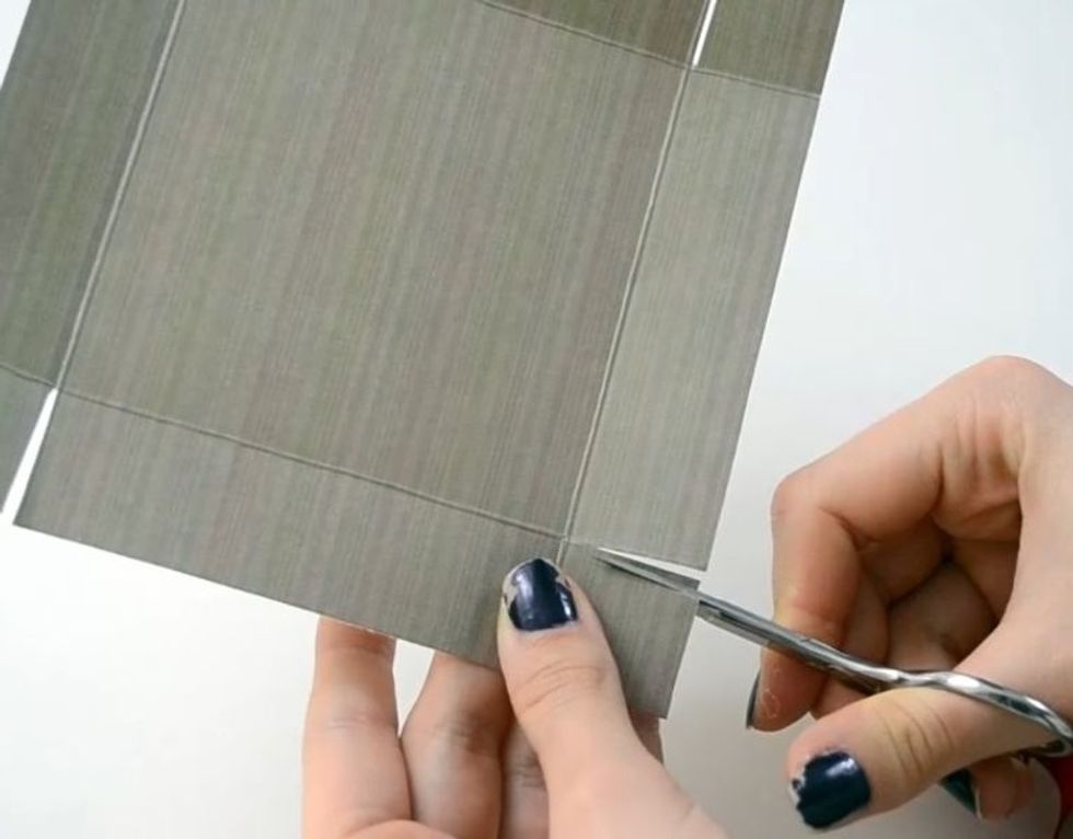 Take the designed paper and cut V shapes as well.