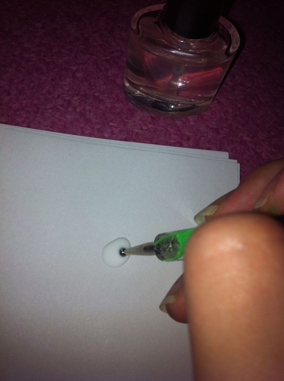 Take the dotting tool, and dip it into the polish.