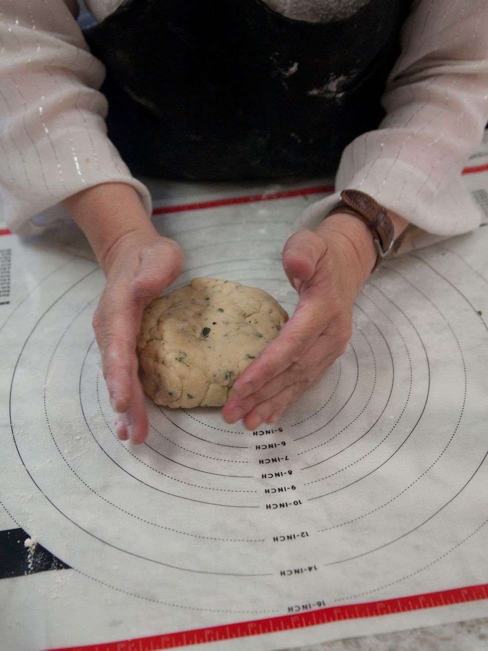 Take the dough out of the bowl and shape it into a round.