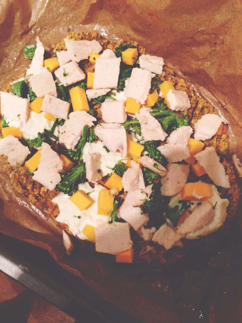 Take the dough out of the oven. Spread the low fat cream cheese, broccoli, butternut squash and chicken on the pizza.  Heat for 7-10 mins.