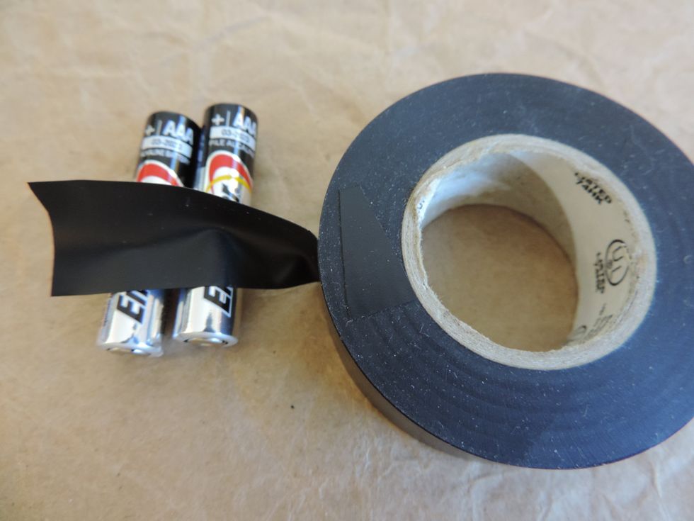Take the electrical tape and wrap it around the center of the two batteries. Bundling them together.