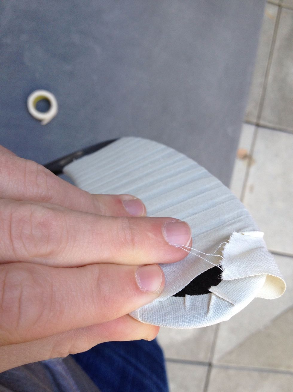 Take the excess tape from the front of the blade, push it against the back of the blade, almost like folding it over. Continue until no more loose tape and all tape is firmly against the blade.