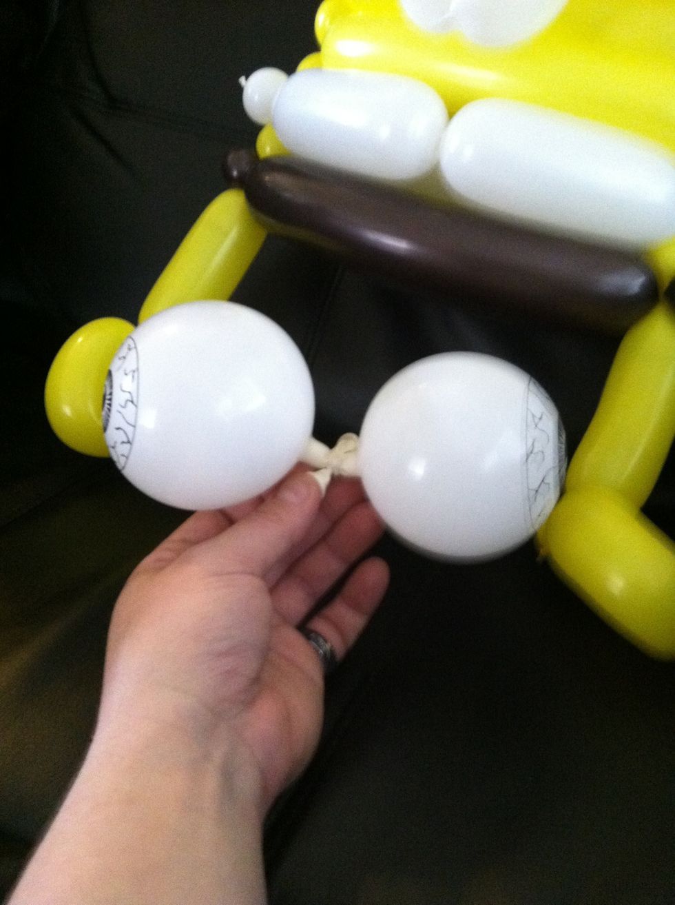 Take the eyeballs and tie them together, leaving a bit of the nozzle on each side