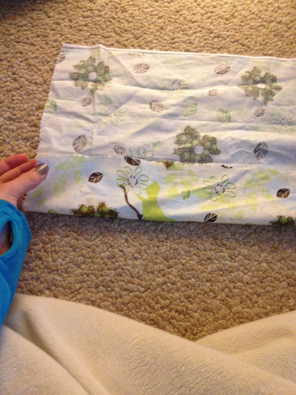 Take the fabric and fold it over to the crease.