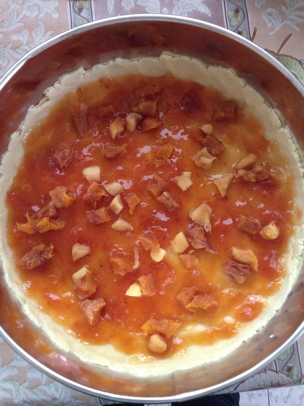 Take the first dough out of the freezer and spread the jam, then the fruits