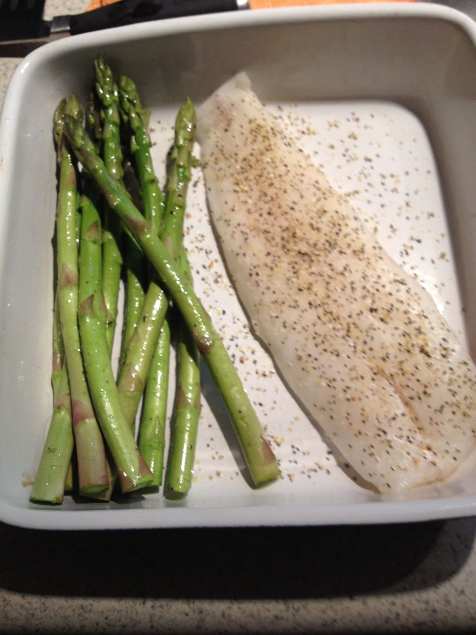 Take the fish out of the package & put it in the dish by the asparagus. Sprinkle with lemon pepper (or any seasoning you like!). Bake for 15-20 minutes (or until the fish is opaque & flaky).