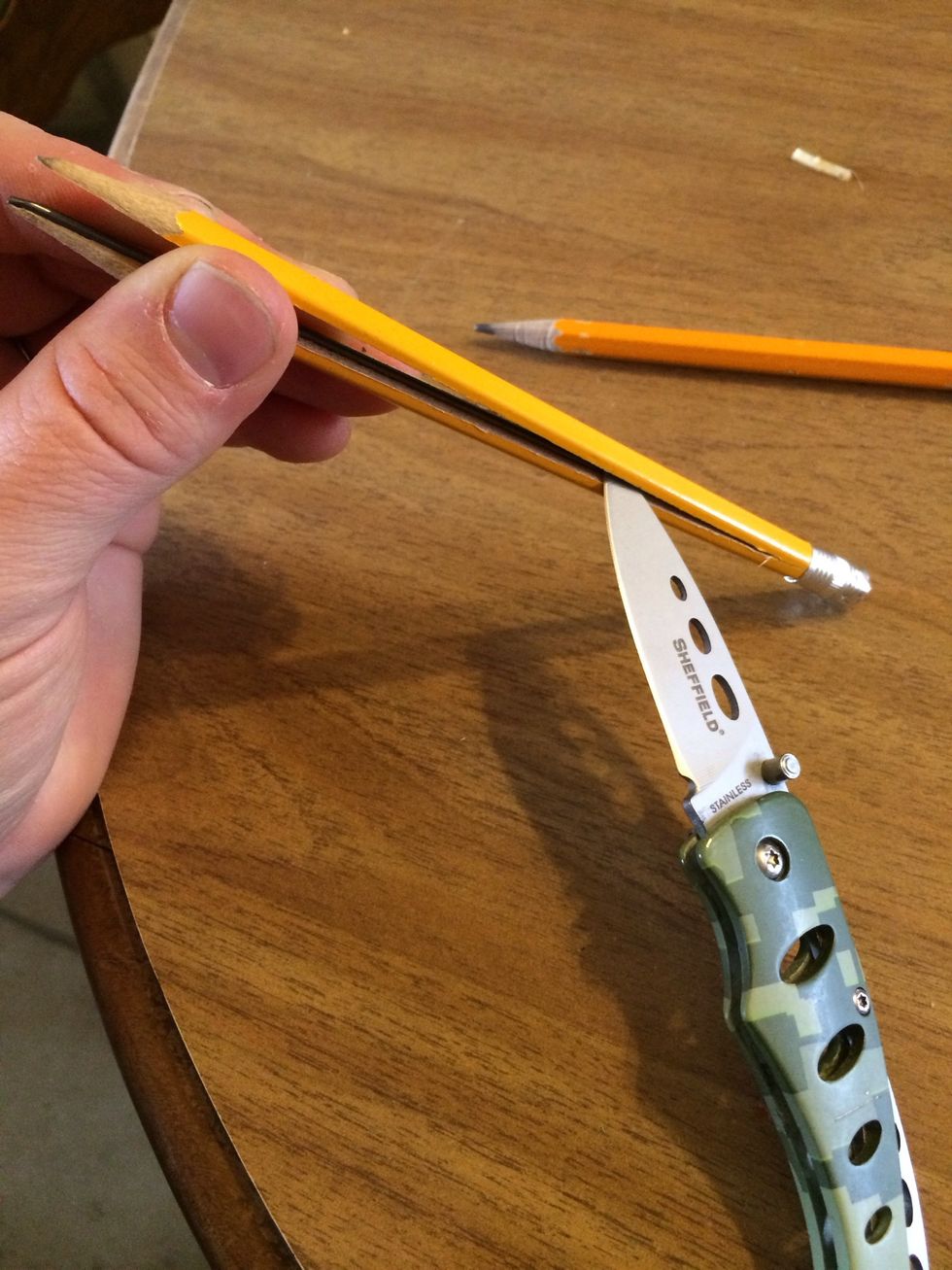 Take the graphite out of the pencil. Old folks called it lead. Pretty awesome right? Find the crease and gently split it apart. Be careful don't cut your fingers off. Fingers look better attached.