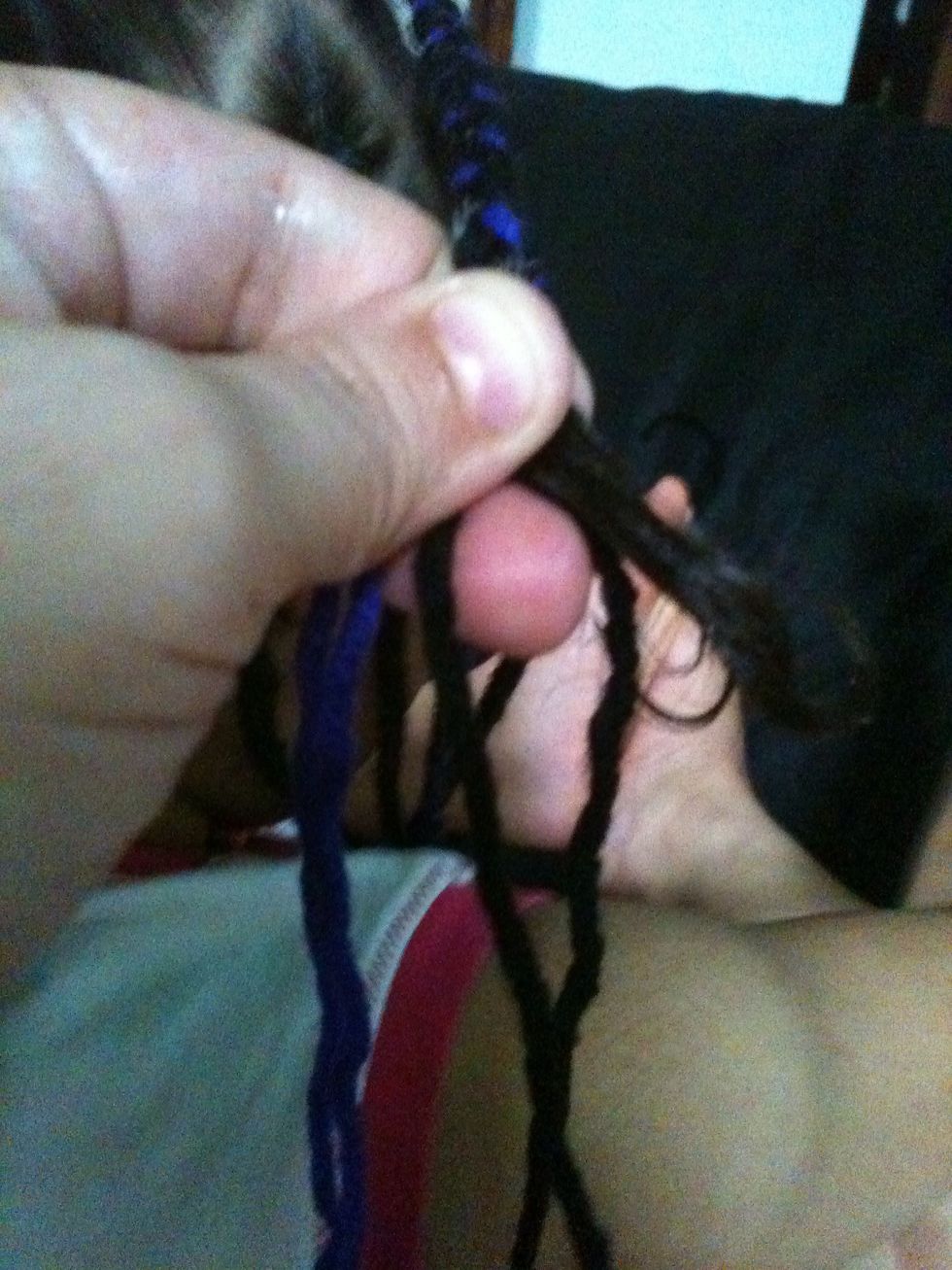 Take the hair and add one strand of yarn to it