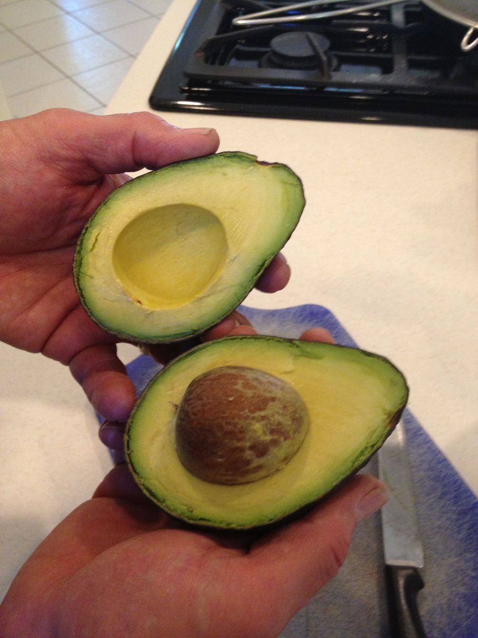 Take the half without the pit and cut it lengthwise.