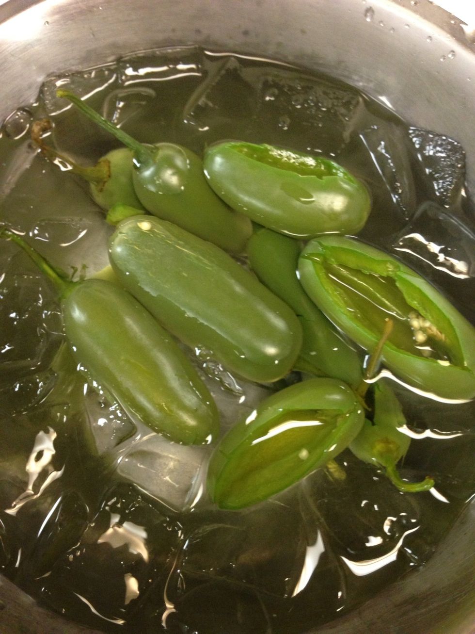 Take the jalape\u00f1os out of the boiling water and put them in a bowl of ice and water