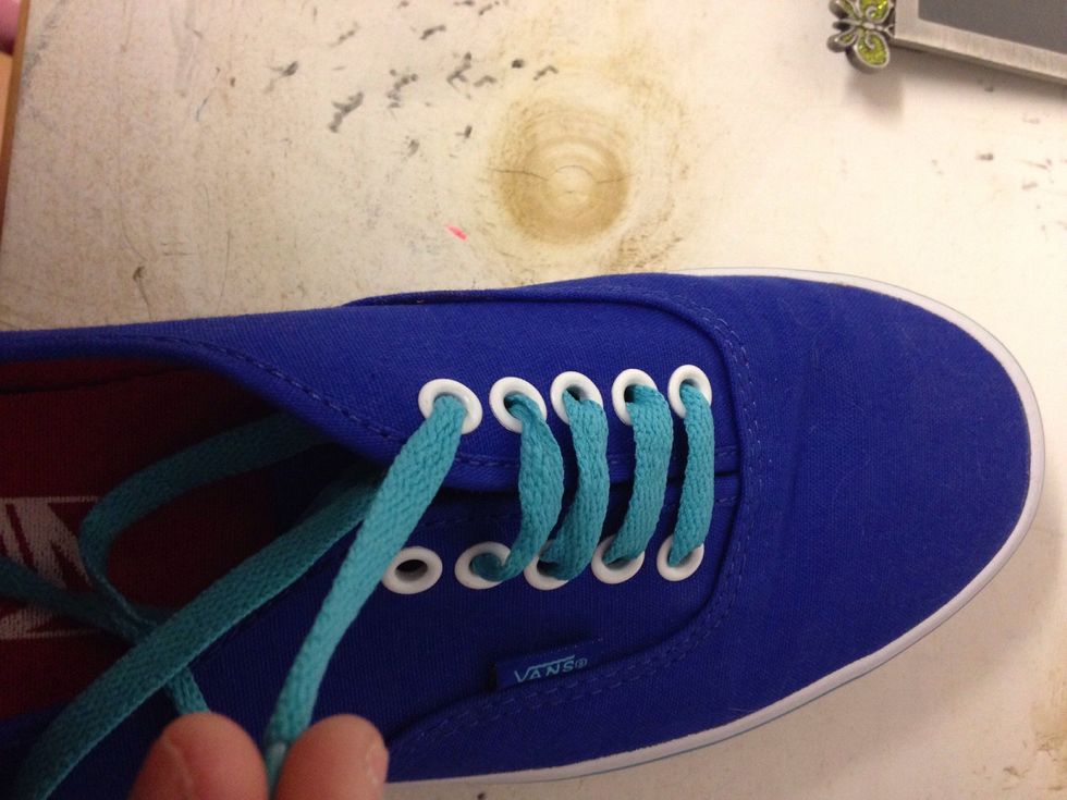 Take the lace on the left and loop it on the right