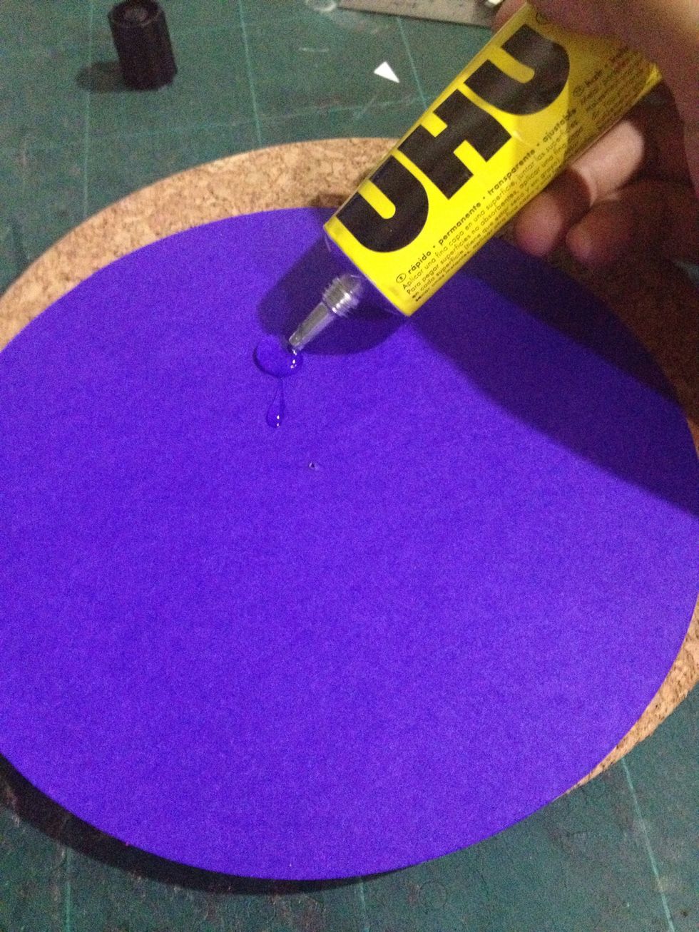 Take the larger round and stick onto the cork board using glue.