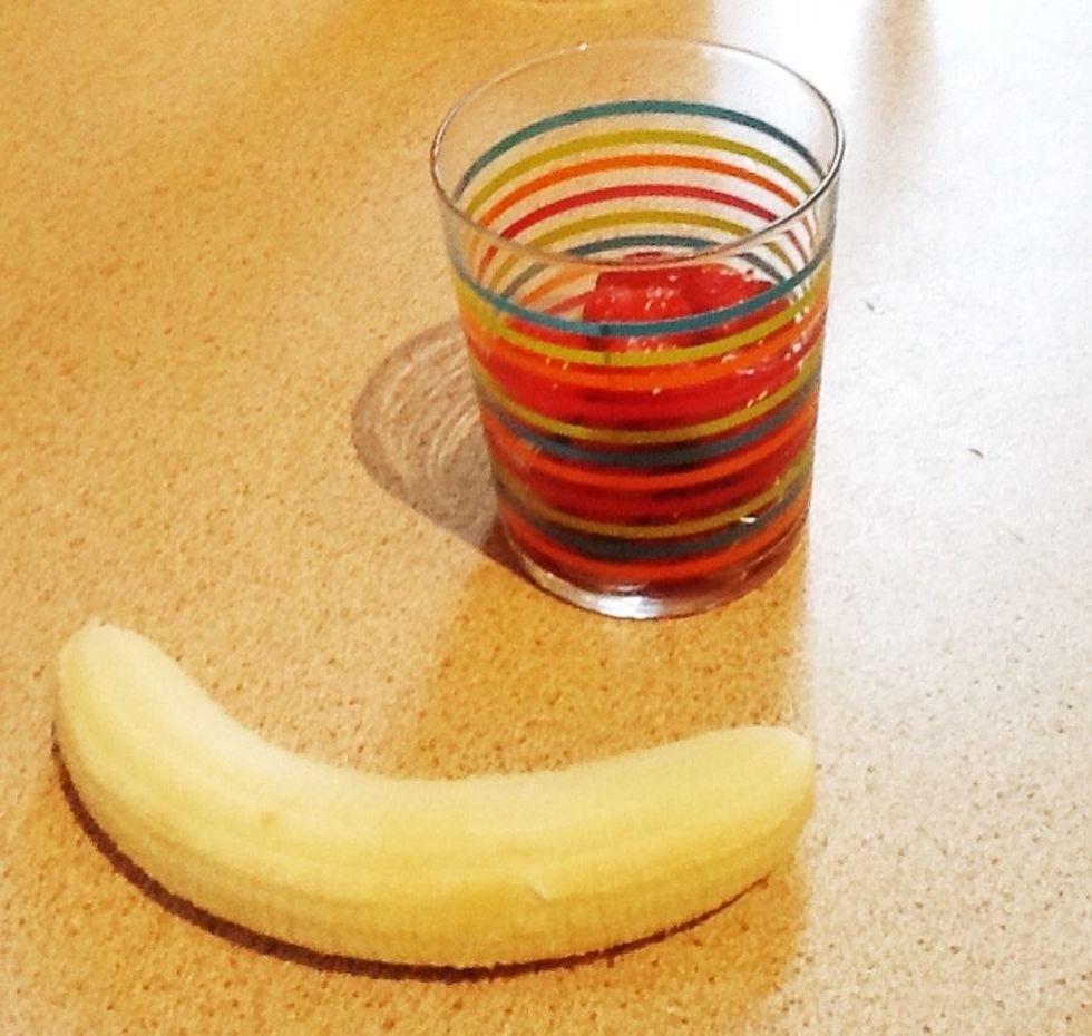 Take the leaves off your strawberries (you will need about a cup full)  and peel your banana.